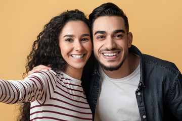 Cheerful Young Middle Eastern Couple Taking Selfie Together, Happy Millennial Arab Man And Woman...