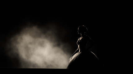 A silhouette of a ballerina in a classic costume on a dark background with soft lighting