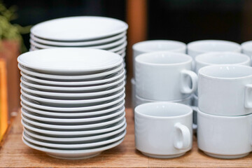 Closeup clean plates stack on a table ready for use