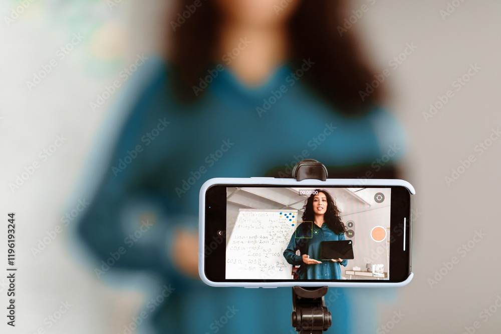 Poster closeup of smart mobile phone taking live of lady teacher giving lesson with math formulas on black 