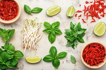 Traditional Beef Pho with green onions, bean sprouts, lime wedges and basil leaves as garnish.  © tienuskin