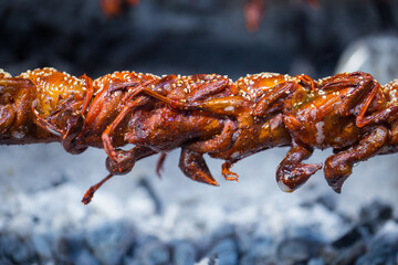 Grilled bird, grilled quail, sold at a street market in Thailand, street food