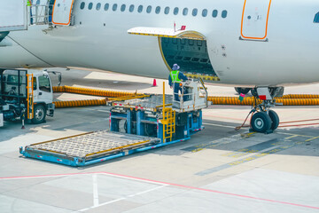 Preparing to load on a forklift into the cargo hold of a passenger jet aircraft. Loading of luggage...