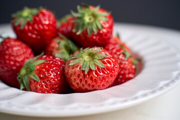 fresh strawberries in white porcelain plate