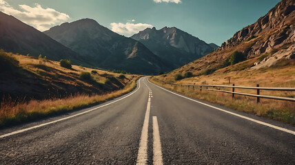 Naklejka premium Scenic mountain road with clear skies and distant hills
