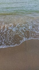 the beauty of the beach with few waves and white sand
