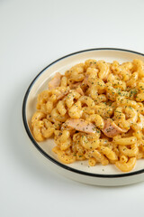 A creamy, cheesy mac and cheese that's sure to satisfy your cravings isolated on white background