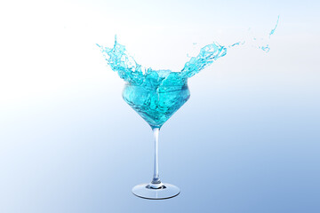 Blue cocktail with splashes on a plain background. Splashing blue cocktail on background.