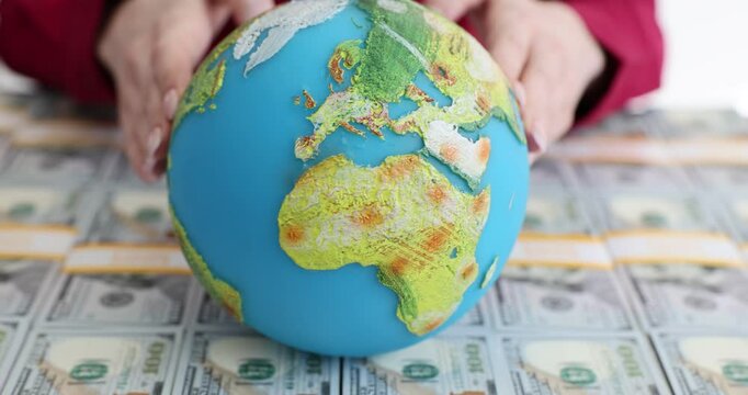 Studying the world economy with a globe and mone