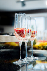 champagne with strawberries on catering table