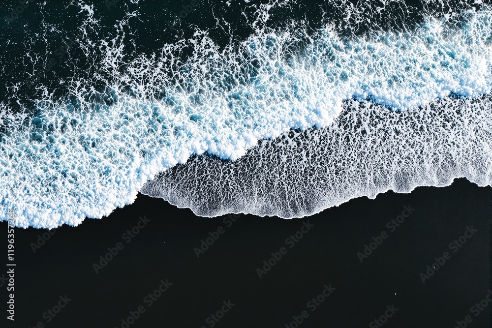 Poster Aerial view of ocean waves crashing on dark sand beach, creating dynamic contrast and intricate foam patterns.