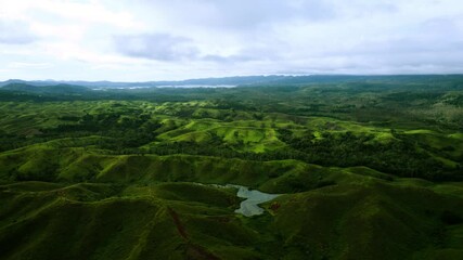 Aerial view of the pond in green hills and valleys of Sogeri Papua New Guinea
