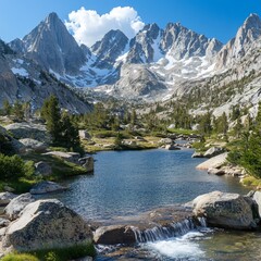 Majestic mountain range reflected in a serene alpine lake with a small waterfall.