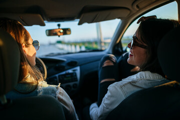 Young women traveling in a car. seen from the inside.