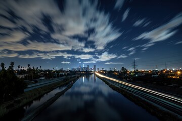 Fototapeta premium Night Cityscape Reflection: Los Angeles Skyline at Night with Moving Clouds and Light Trails