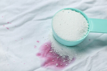 Laundry detergent on stained clothes, closeup