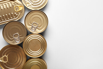 Assortment of tin cans with fish on white background