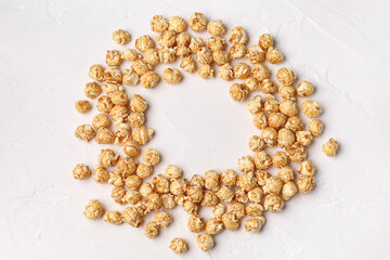 Frame made of crispy popcorn on light background