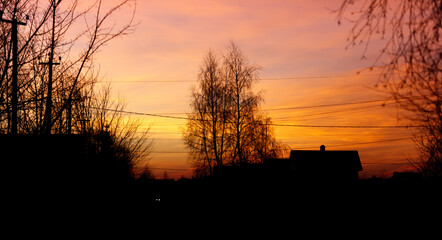A beautiful sunset over a rural area with a house in the background