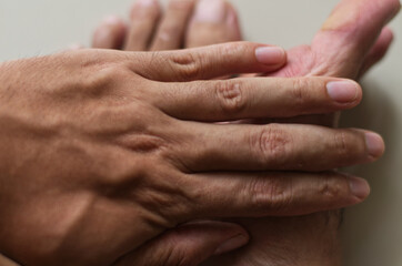 Fototapeta premium Close-Up of Hands Touching in a Friendly or Supportive Gesture