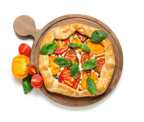 Wooden board of tasty tomato galette with basil on white background