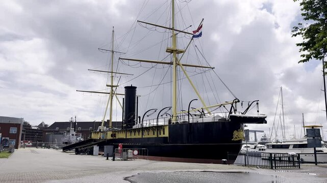 Relic of Naval Power HNLMS Schorpioen, a 19th-Century Ironclad Warship, Preserved as a Museum Ship in Den Helder, Netherlands, on a Cloudy Day