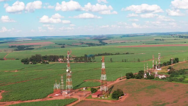 Drone aerial landscape of communications towers antennas infrastructure network systems installation equipment in farmland rural countryside Brazil South America industry technology.