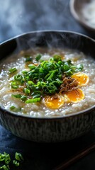 Delicious congee rice porridge simmers in a bowl, releasing steam into the air