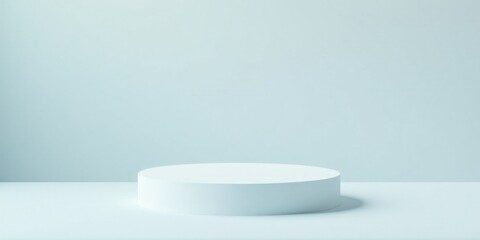 A minimalist pastel blue backdrop showcasing a simple, cylindrical white platform ideal for product display or presentation purposes.