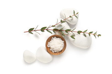 Composition with bowl of sea salt, spa stones and eucalyptus branch on white background