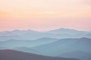 Fototapeta premium Mountain Range Covered in Soft Pink Light at Sunrise Creating a Dreamy Landscape