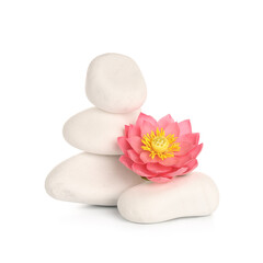 Stack of spa stones with decorative flower on white background