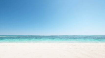 Obraz premium Serene beach view with clear blue skies and gentle waves.