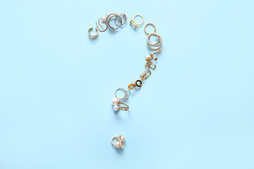 Question mark made of different female accessories on color background