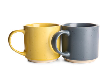 Stylish ceramic mugs isolated on white background