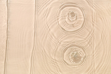 Texture of clean water with splashes on beige background
