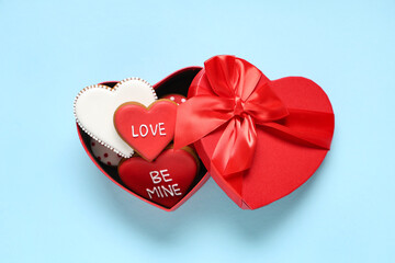 Box with heart shaped cookies on blue background. Valentine's day celebration