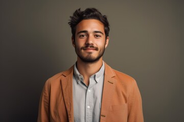 Fototapeta premium A man in a tan jacket and white shirt is smiling for the camera