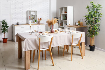 Stylish table setting for dinner in kitchen