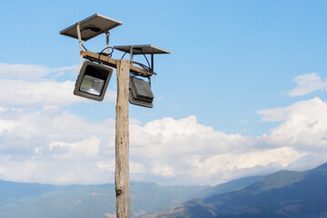 Solar Cell Light Led Lamp setting on a tall wooden pole on the top of a high mountain