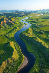 Fototapeta premium Aerial View of a Winding River Through Lush Green Hills