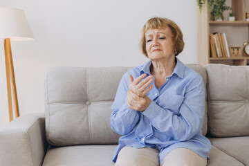 Elderly woman suffering from pain in hand, arthritis old person and senior woman female suffering...