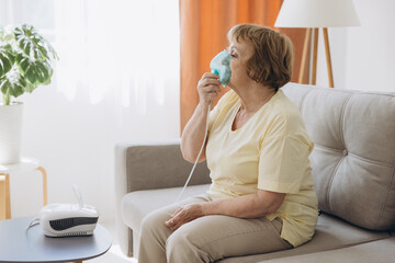 Sick senior woman has a viral infection or flu, labored breathing, asthma. An elderly female is...