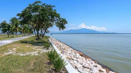 Naklejka premium Serene lakeside path with mountain view