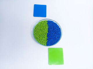 plastic masterbatch, masterbatch granules, polymer carrying pigment poured into a glass cup forming...