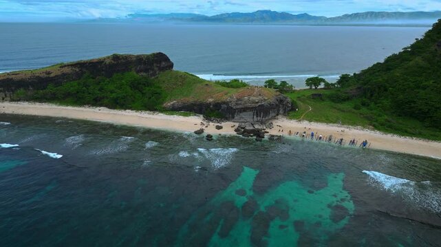 Drone flying away from the Capones Island, Pundaquit, San Antonio, Zambales, Philippines. Side view