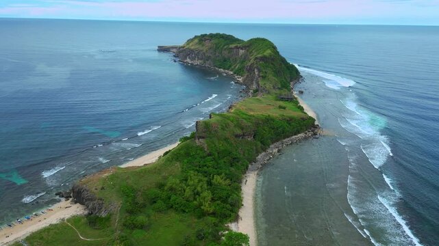Aerial shot very high above mountain range at Capones Island, Pundaquit beach. Zambales, Philippines. Morning flight