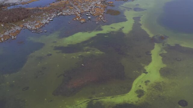 Dynamic aerial top-down shot of a large turlough (seasonal lake) in Burren National Park