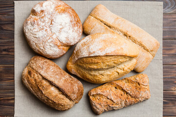 Assortment of freshly baked bread with napkin on rustic table top view. Healthy unleavened bread....