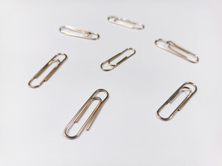 Though a small object, the paperclip stands out, emphasizing the beauty in everyday items.